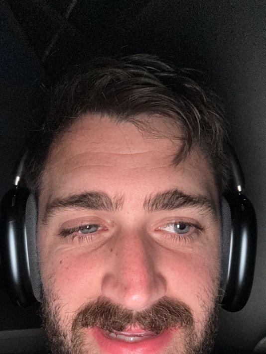 Gregory Cooke exhausted late at night in headphones during his sales call years