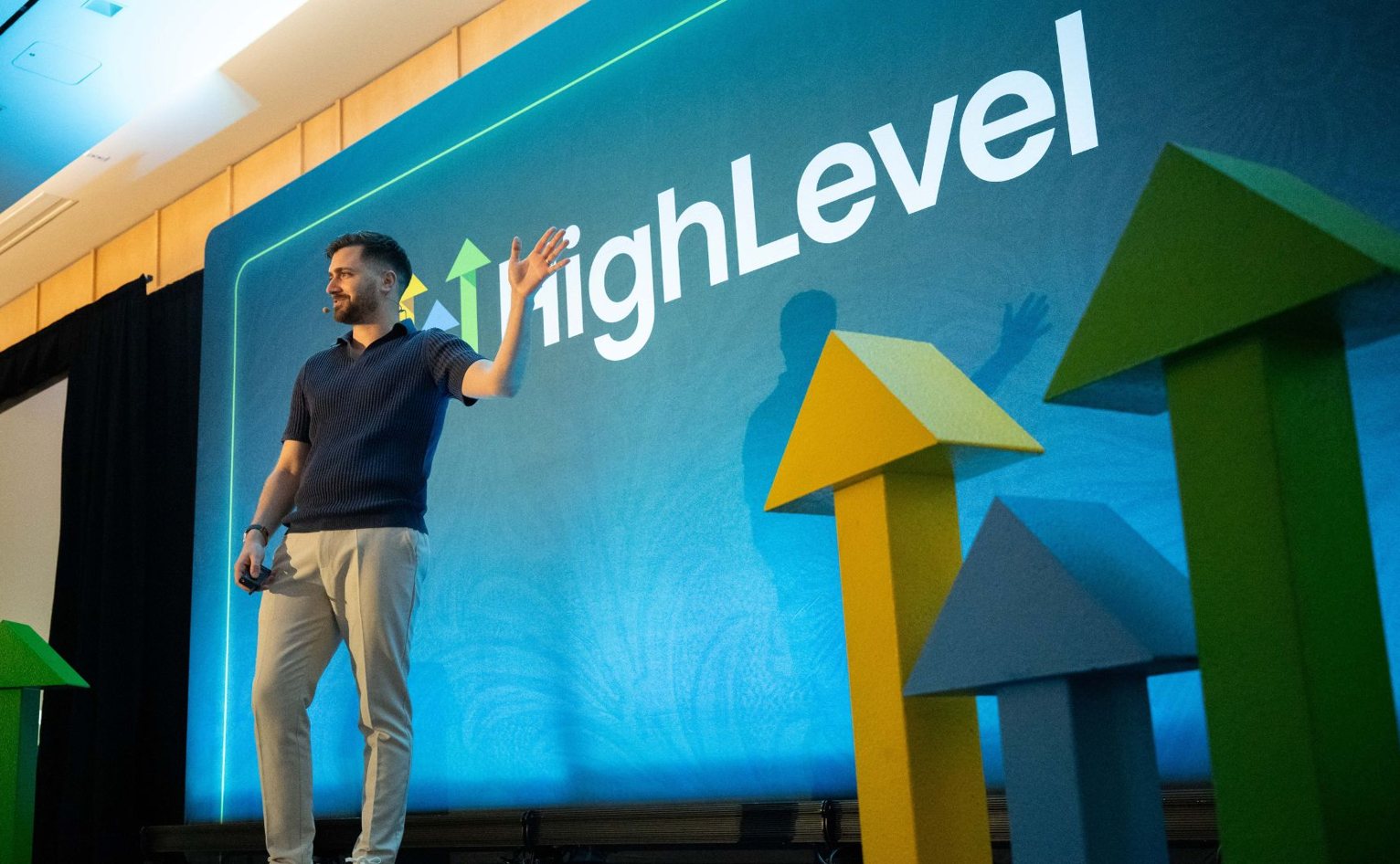 Gregory Cooke speaking on stage at a HighLevel event